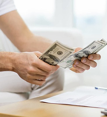 pngtree-mans-hands-counting-money-in-closeup-view-at-home-photo-image_18950786