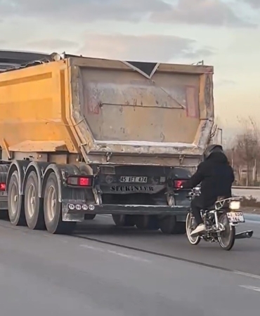 seyir-halindeki-tirin-pesinde-motosikletli-tehlikeli-yolculuk-mDLk5MBN.jpg